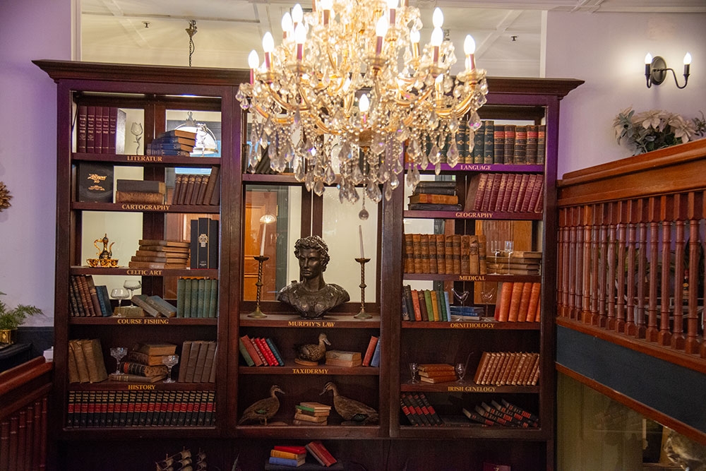 Chandelier and book shelves at Trove Bar