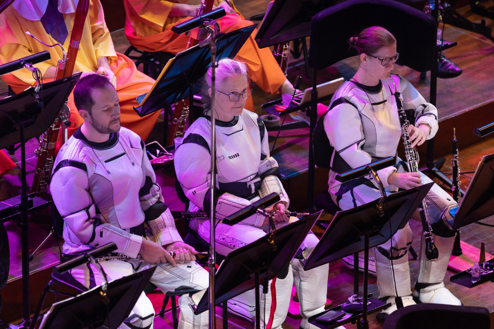 people sitting in custom as part of an orchestra