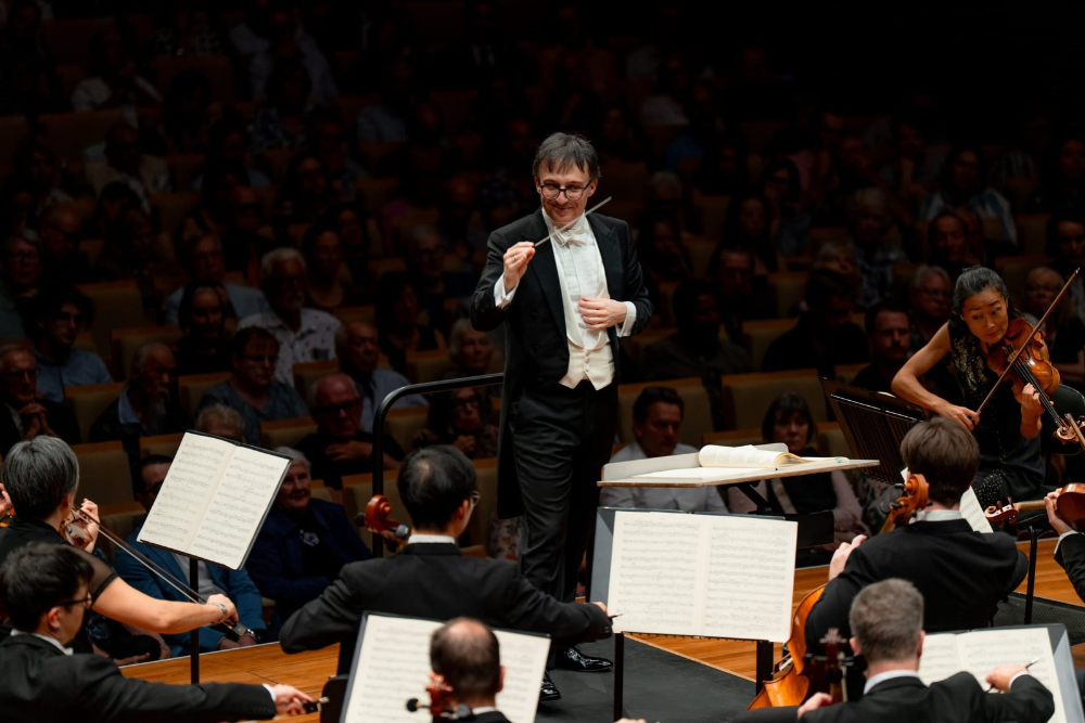 Conductor standing on stage