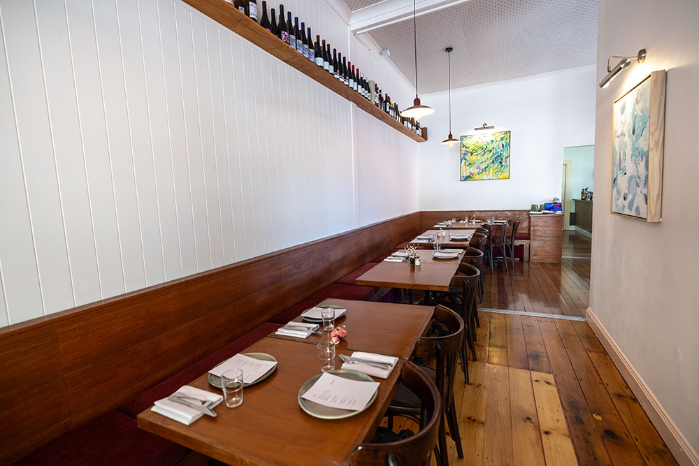Tables along wall inside Venner