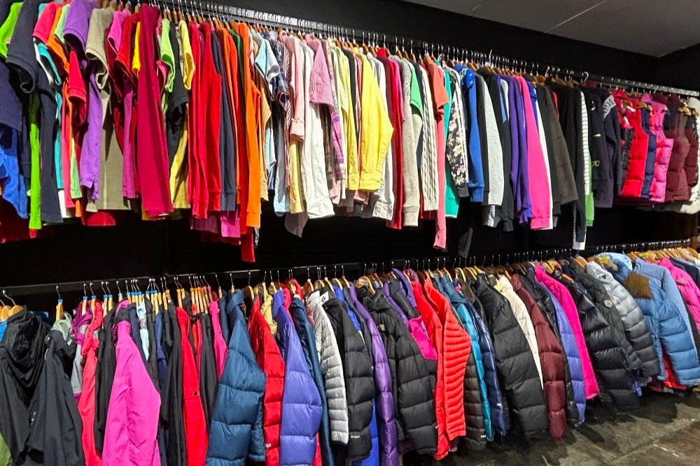 Racks of men's shirts and jackets inside Vintage Street, Stones Corner 