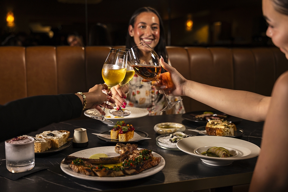 Diners toasting NYE at Bacchus Restaurant at Rydges South Bank