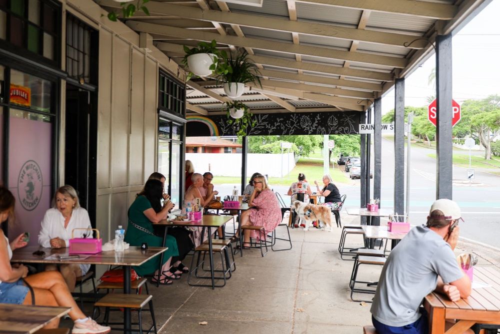 People sitting on tables enjoying their meals 