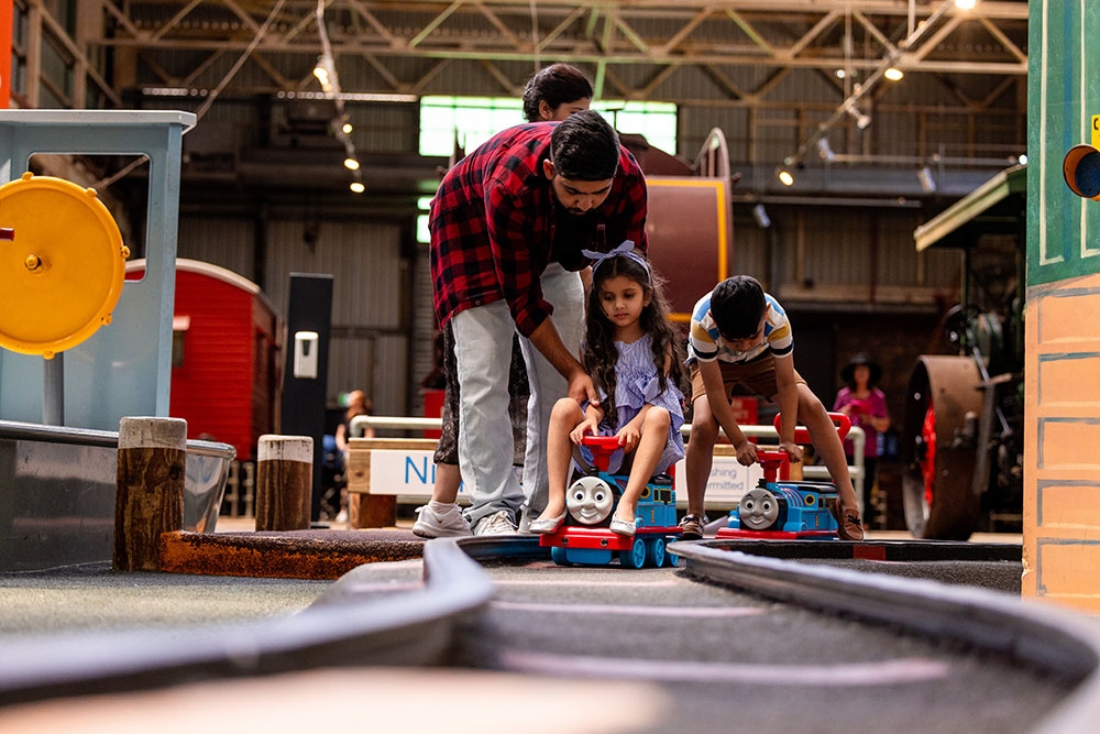 Family in play area at Queensland Museum Rail Workshops