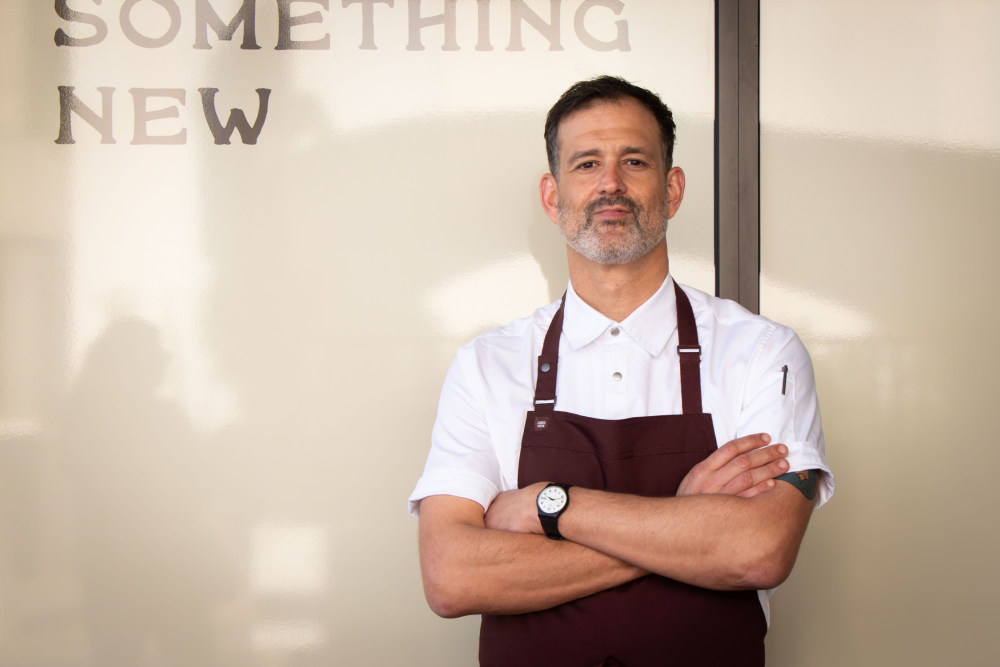Chef standing in front of restaurant 