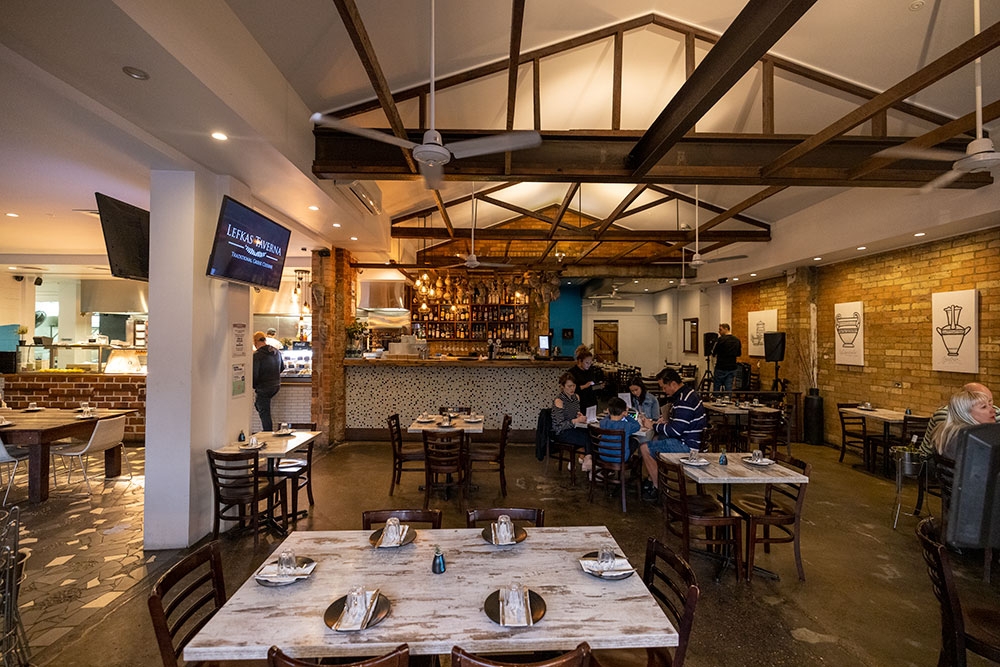 People dining at tables inside Lefkas Taverna