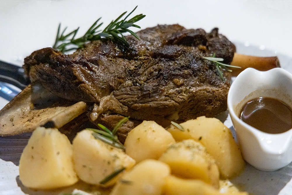 Meat and potatoes on a plate at Lefkas Taverna