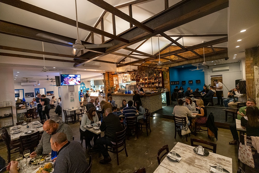 People dining at tables inside Lefkas Taverna