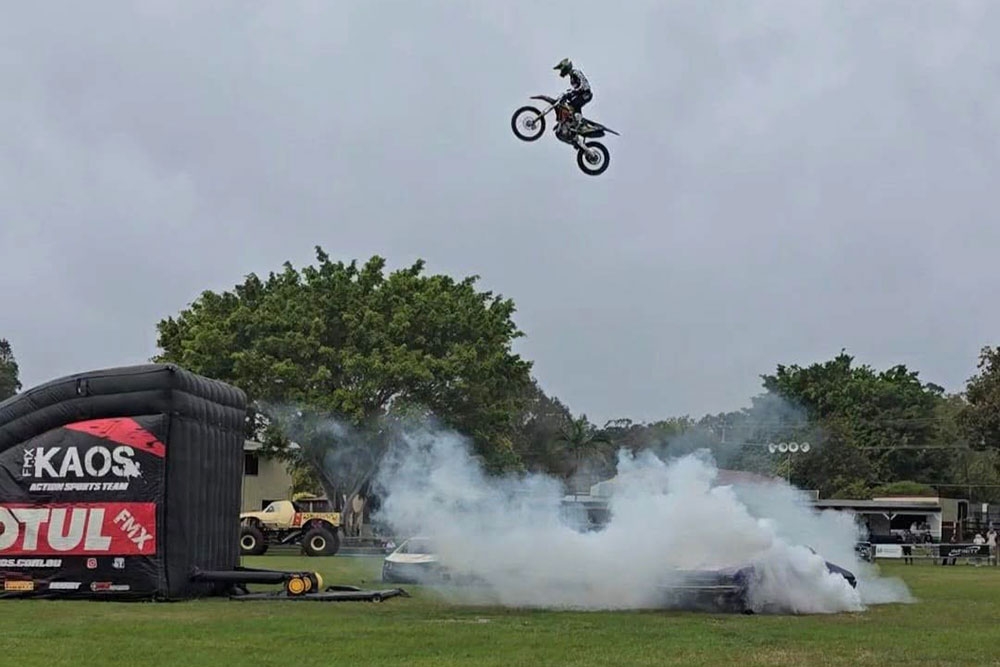 Stunt riders jumping vehicle