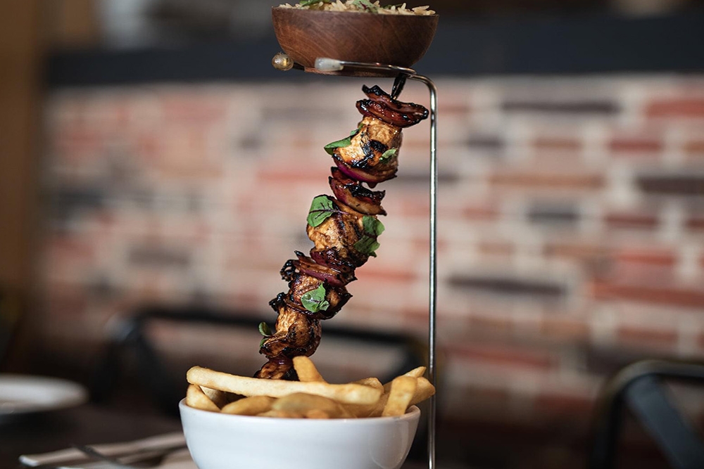 Meat skewer with chips in white bowl at Smokehouse Meat & Co South Bank