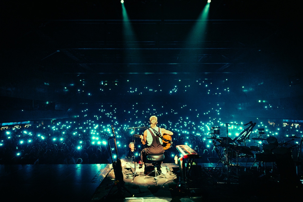Xavier on stage with crowd