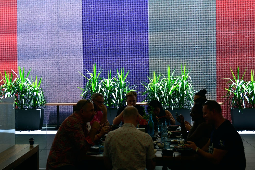 People sitting at table outside Little Saigon Grill restaurant in Brisbane
