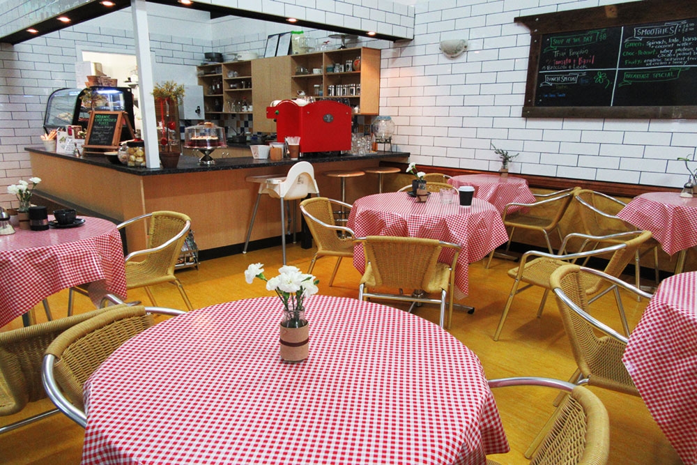 Pink checquered tablecloths on tables inside Marcia's on Montague West End