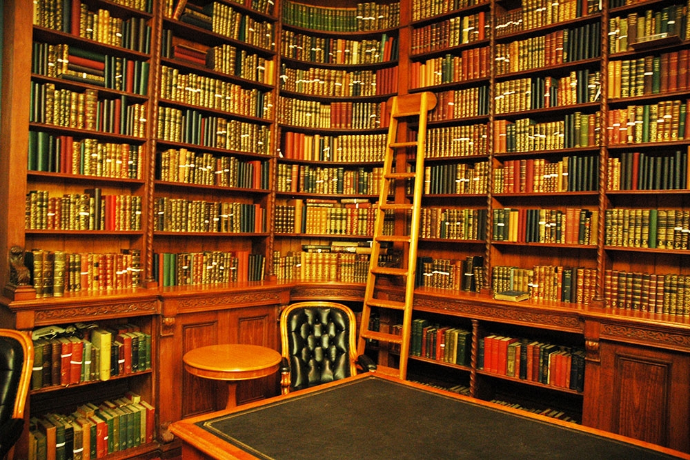 Old leather bound books on shelves inside the O'Donnovan Library in Queensland's Parliament House