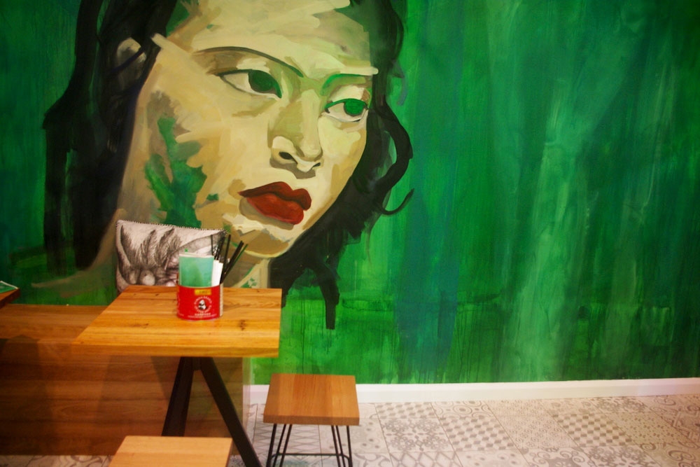 Mural on wall in front of table and chair inside Asian Kitchen Tingalpa