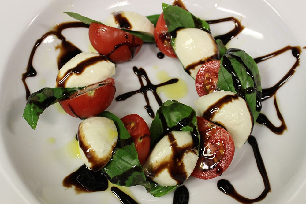 Caprese salad of mozzarella, tomato and basil on a plate at Pizzeria 1760 Yeronga