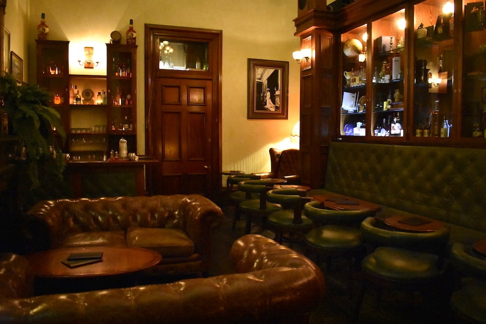 Piano, gramophone and light inside The Gresham Bar dim-lit interior