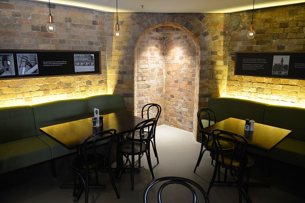 Interior seating lit up at night at Under The Clock South Brisbane