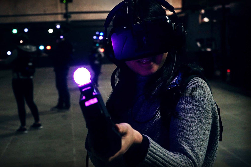 Woman pointing virtual reality equipment at Zero Latency