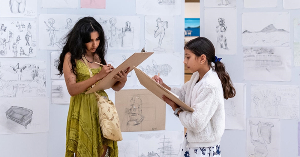 Two people drawing