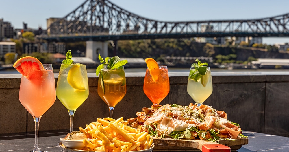 Cocktails and food in front of the Story Bridge