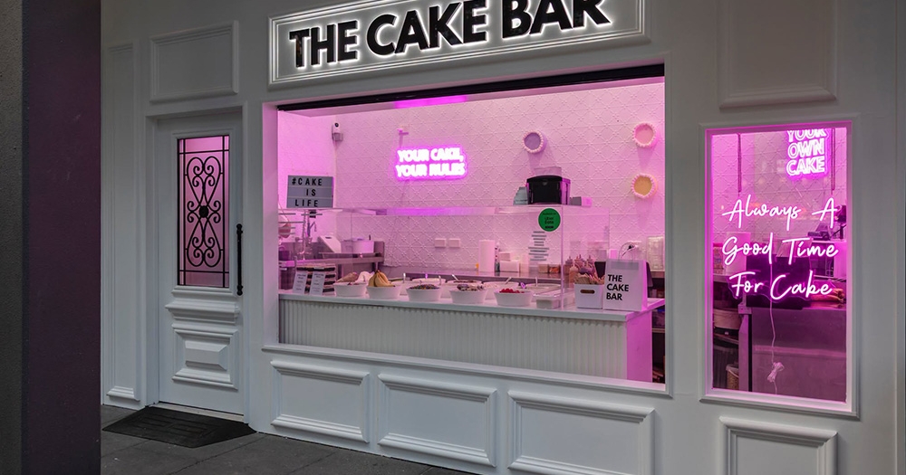 Lit up facade of The Cake Bar