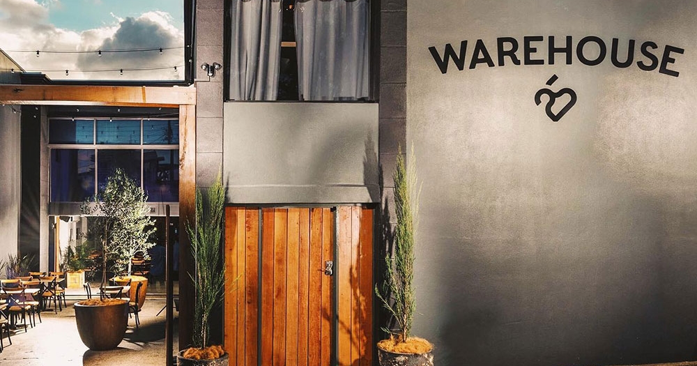 Exterior lit up facade of Warehouse 25, Milton