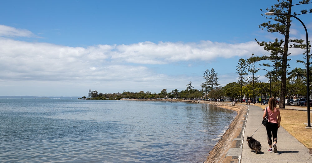 Woman and dog walking Wynnum to Manly 